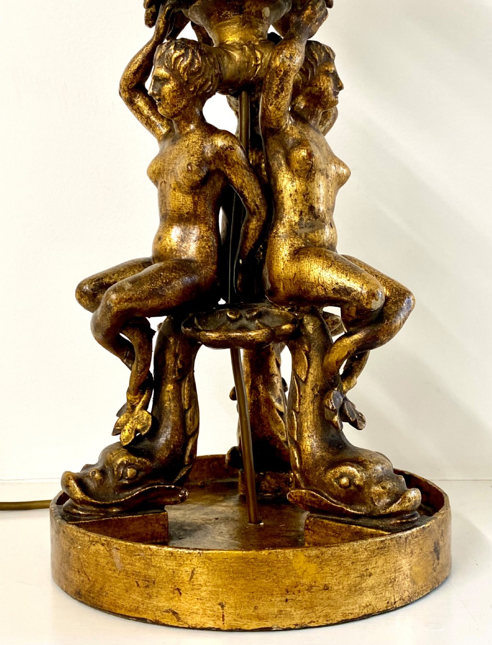 A pair of ornate Italian carved gilded table lamps featuring sculpted female figure supports and floral columns. View IV