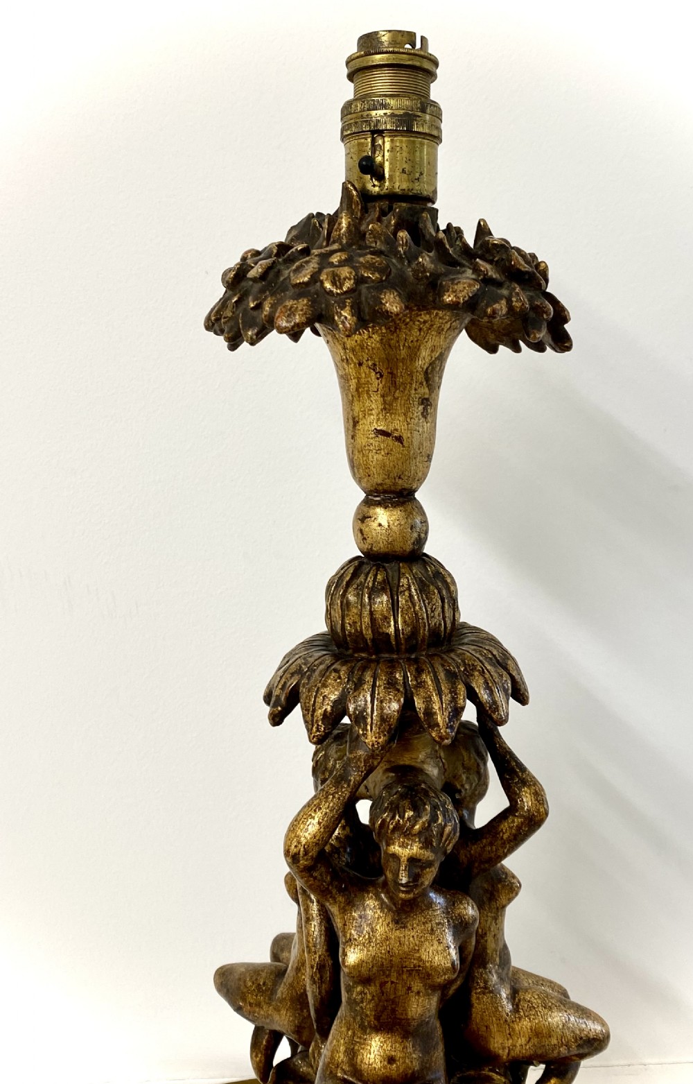 A pair of ornate Italian carved gilded table lamps featuring sculpted female figure supports and floral columns. View V