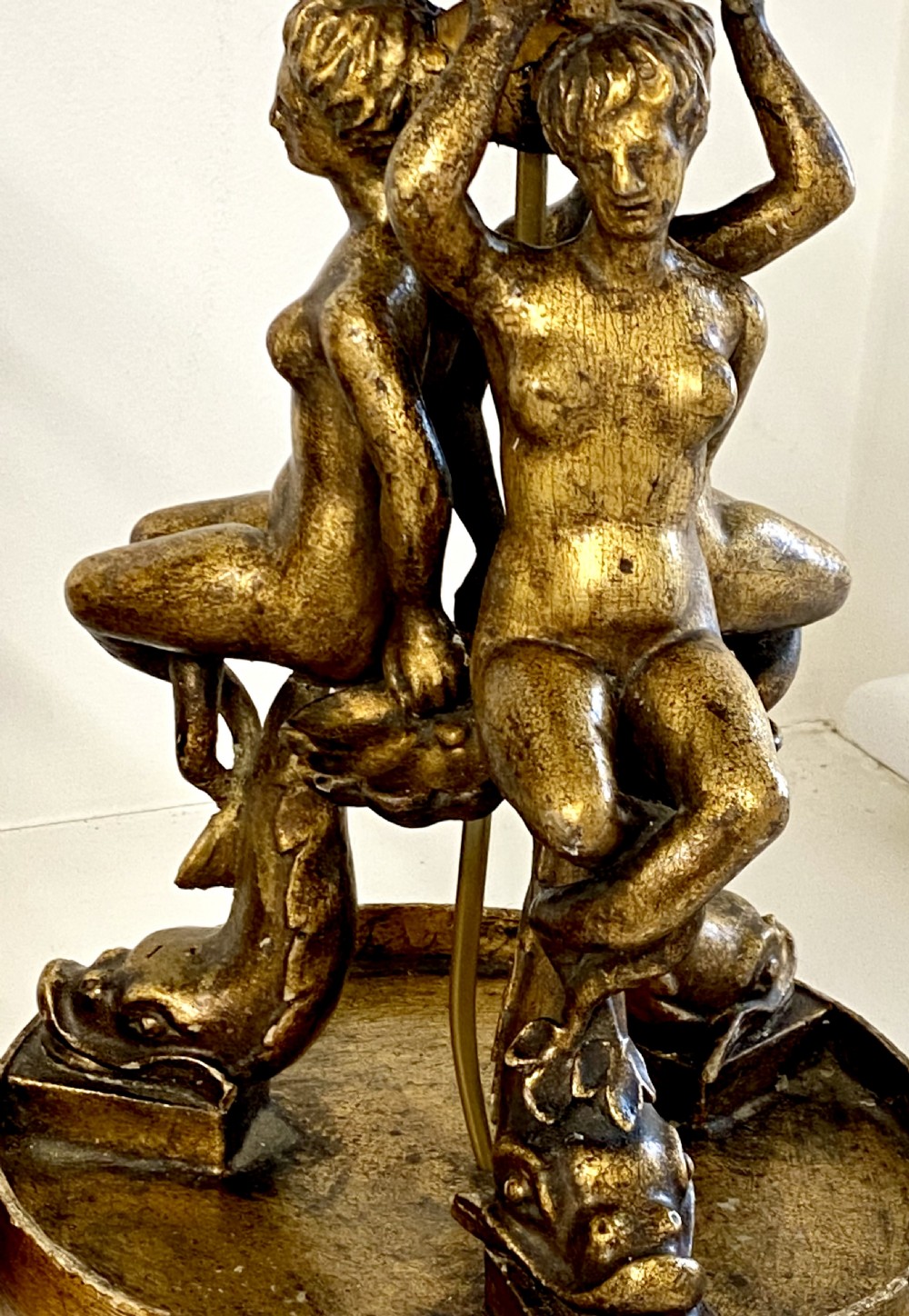 A pair of ornate Italian carved gilded table lamps featuring sculpted female figure supports and floral columns. View VIII