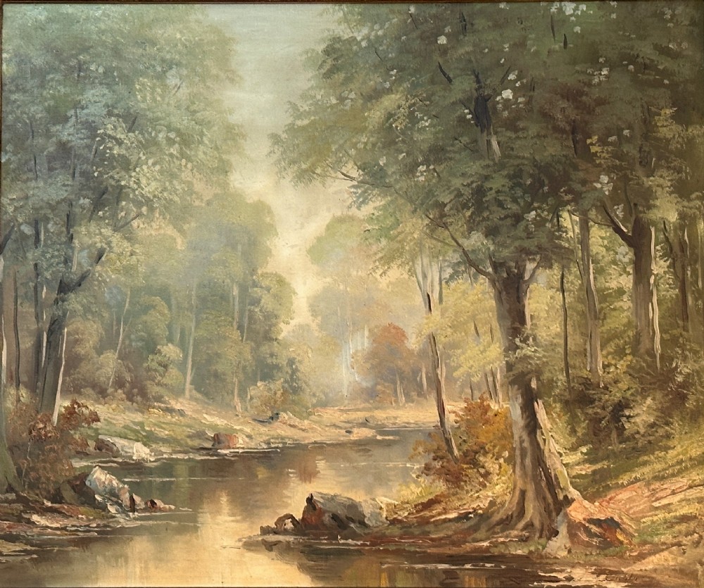 An antique landscape oil painting depicting a calm river flowing through a dense forest, housed in an ornate gilded frame. View II
