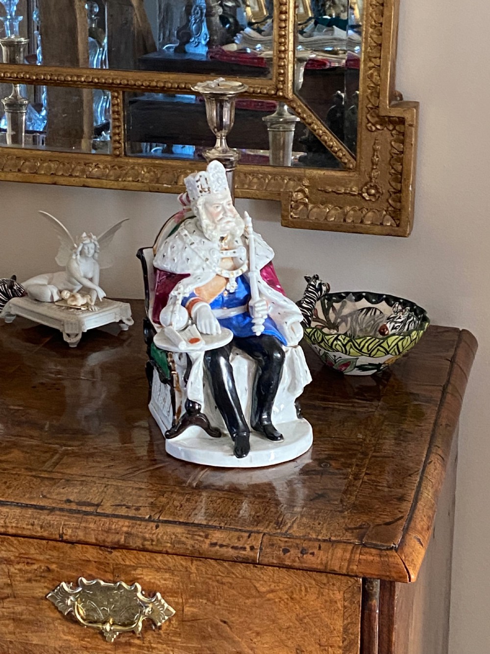 A hand-painted German porcelain tobacco jar sculpted as a seated king wearing a crown and ermine cape while holding a sceptre. View IX