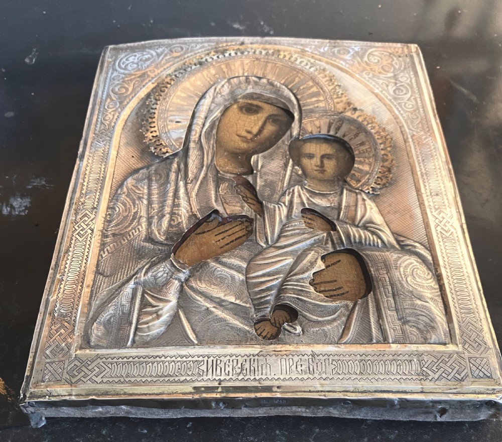 A Russian Orthodox wooden icon encased in an intricately chased silver oklad portraying the Mother of God and Infant Christ. View IV