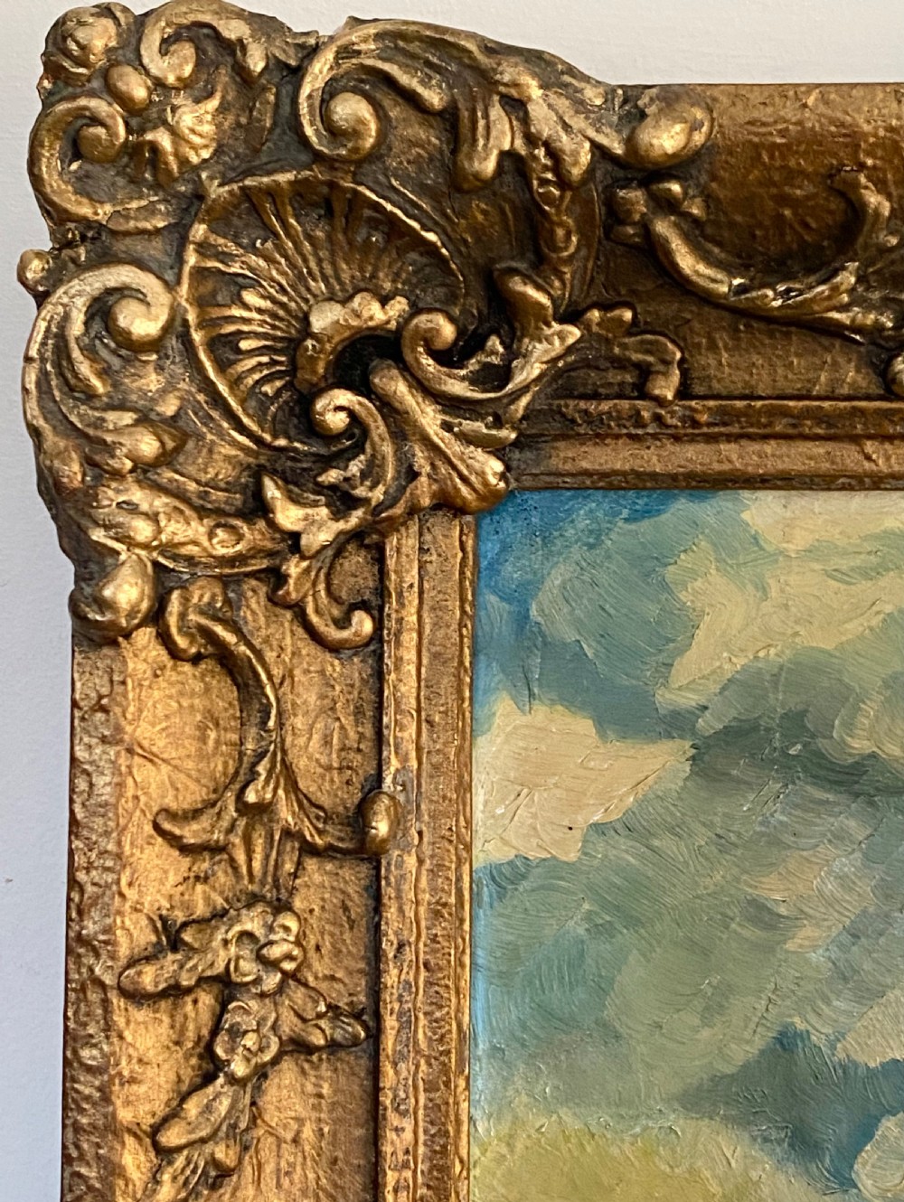 A Dutch Impressionist oil painting on canvas depicting a village alongside a reflective river, presented within an ornate gilt frame. View VII