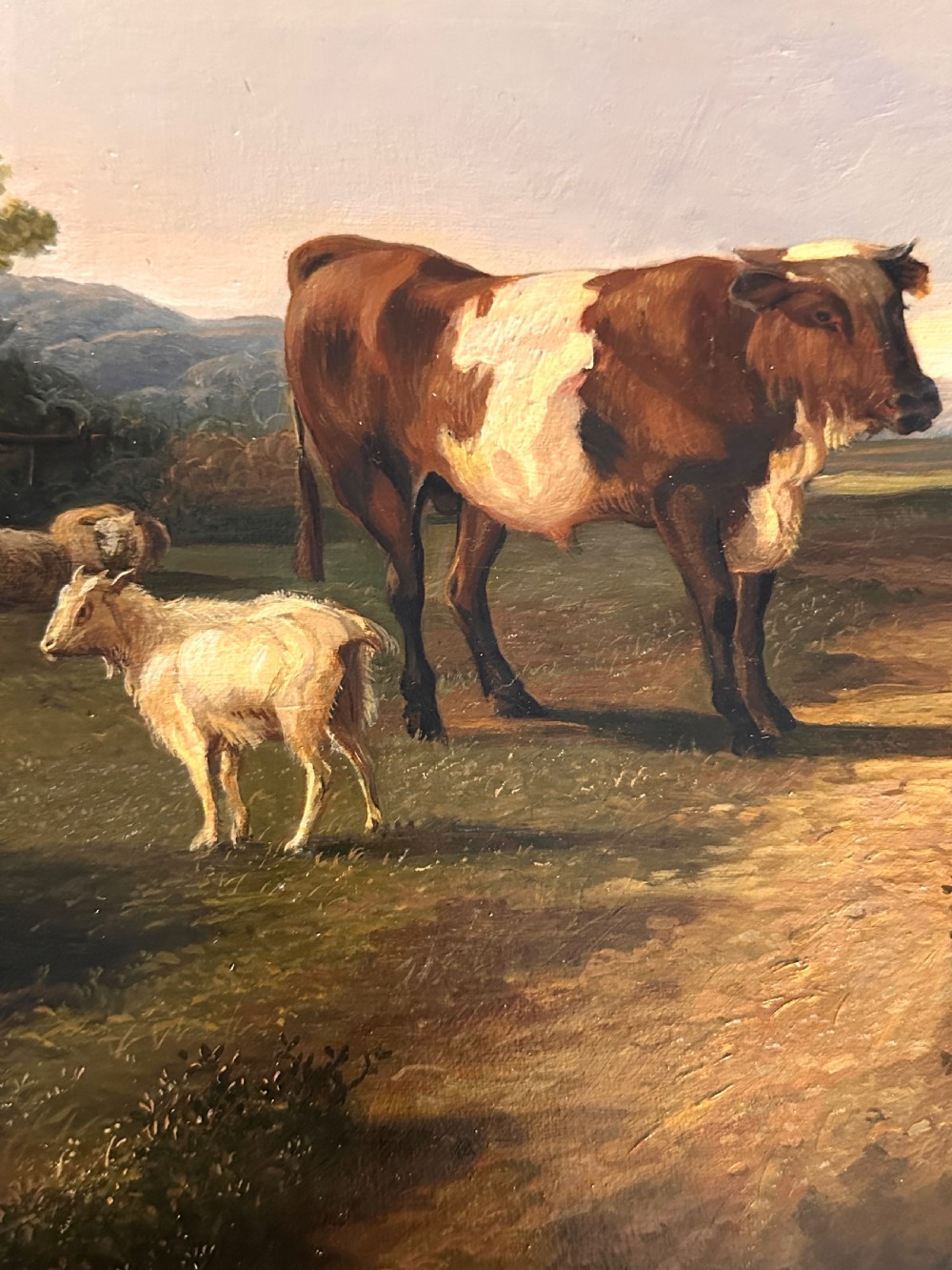 An oil painting on canvas depicting livestock resting in a pastoral field, housed within an ornate gold gilt frame. View IV