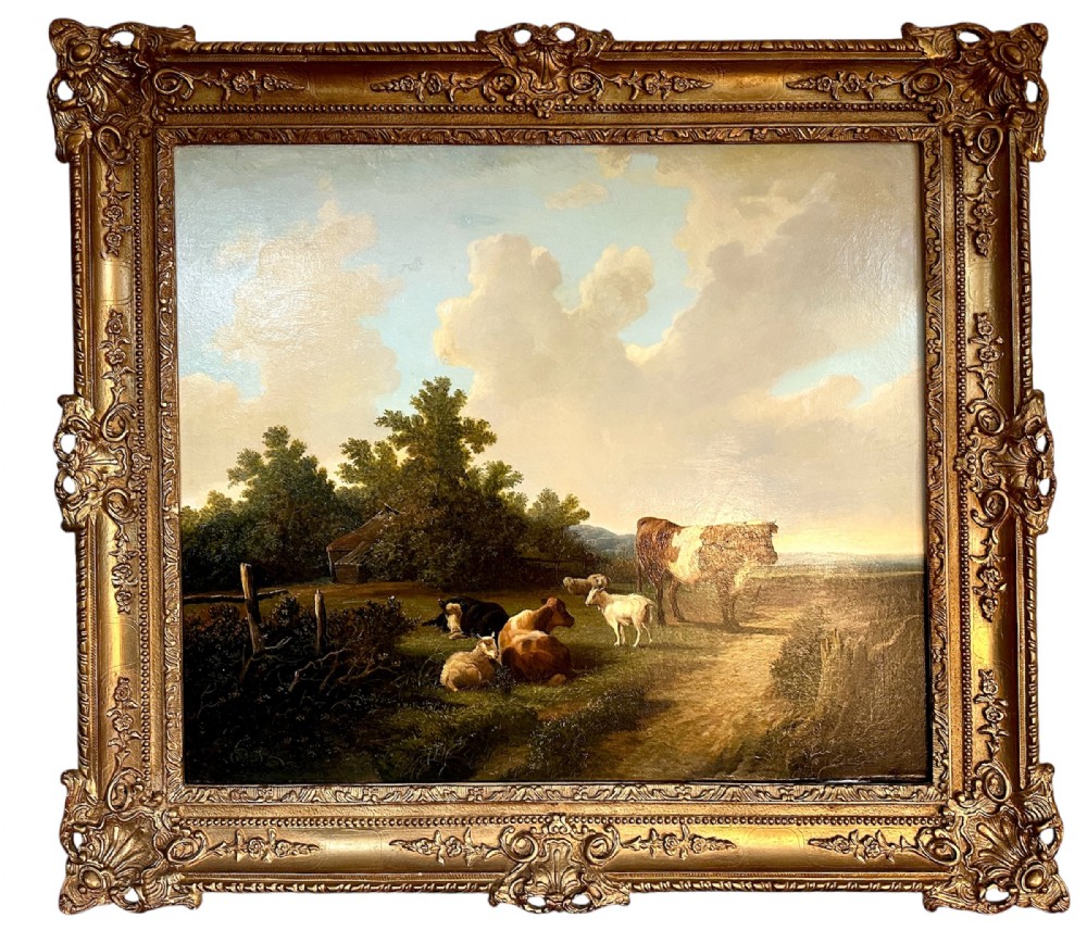 An oil painting on canvas depicting livestock resting in a pastoral field, housed within an ornate gold gilt frame.