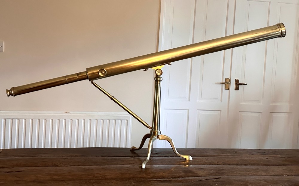 A Georgian brass library telescope mounted on a folding tripod stand with cabriole legs. View II