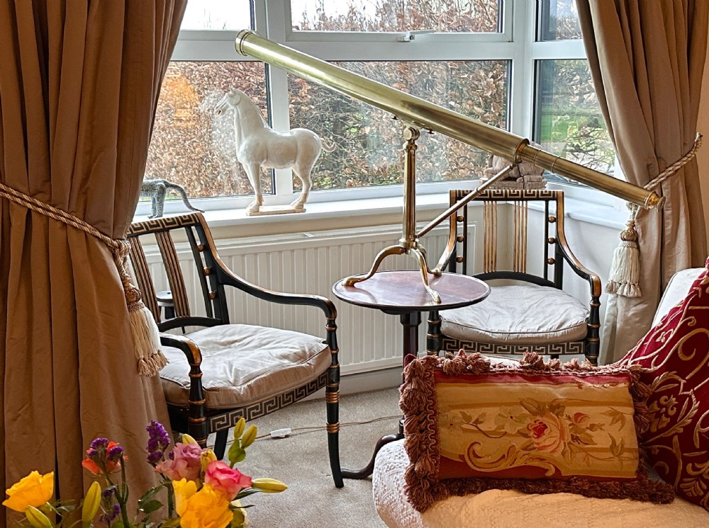 A Georgian brass library telescope mounted on a folding tripod stand with cabriole legs. View V