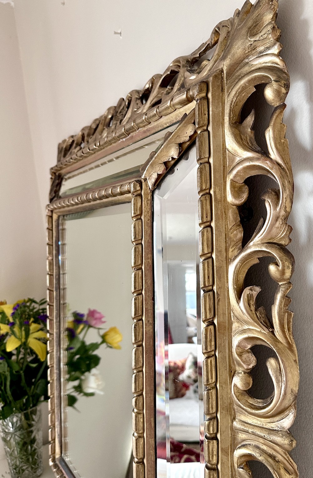 A rectangular giltwood Florentine wall mirror featuring openwork carved scrollwork, beaded inner borders, and mirrored side inserts. View III