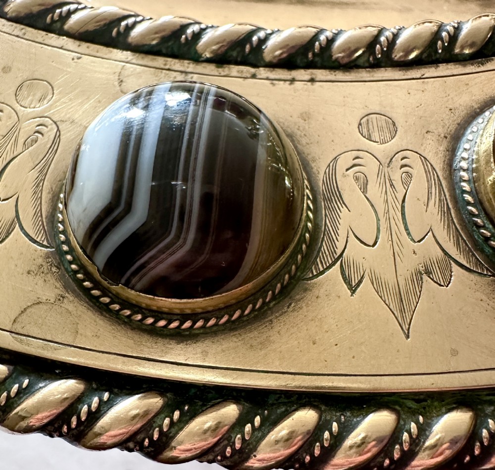 A shallow circular bronze pedestal tazza featuring an engraved interior rim and a border inset with polished banded agate cabochons. View III