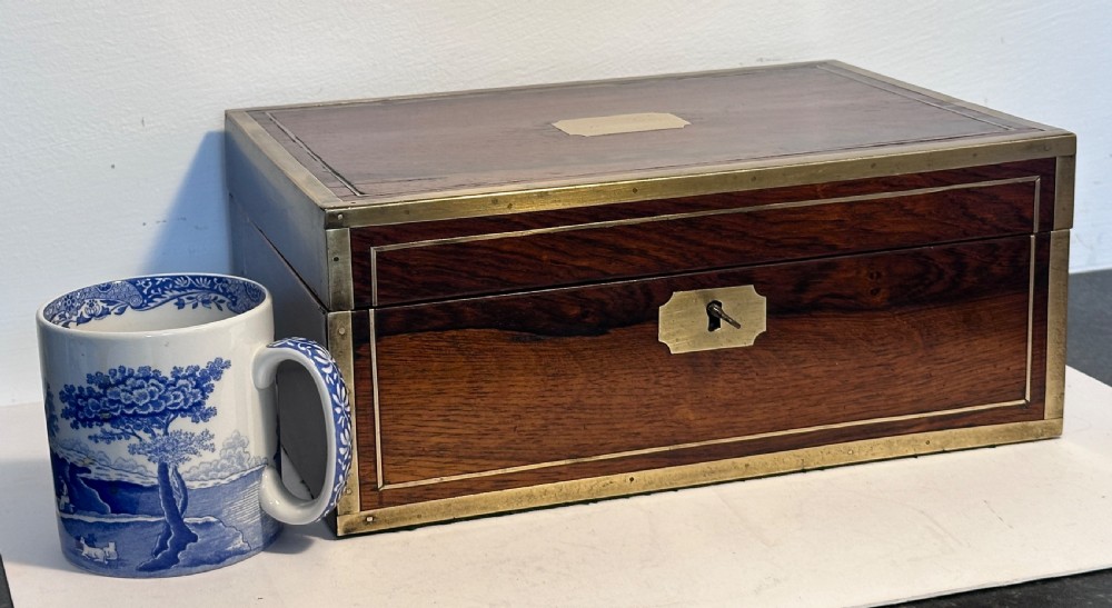A rectangular dark rosewood jewellery box featuring brass corner bindings, brass inlay stringing, a keyhole escutcheon, and a blank brass cartouche on the lid. View VIII