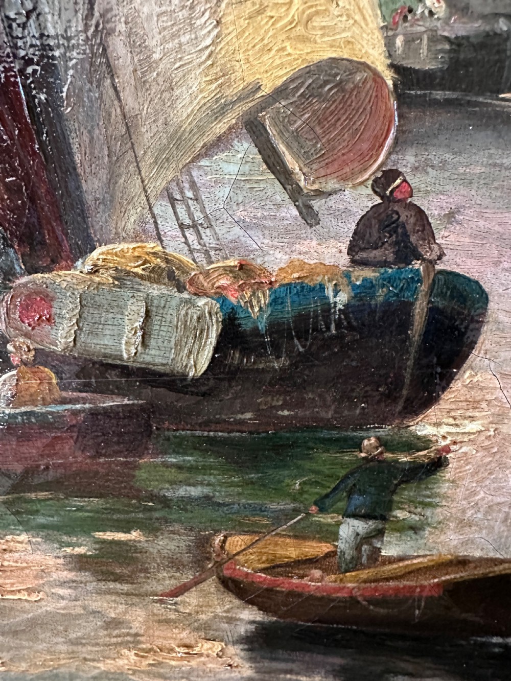 A pair of framed oil paintings on canvas depicting wooden sailing boats docked in a harbour within ornate gold leaf frames. View IV