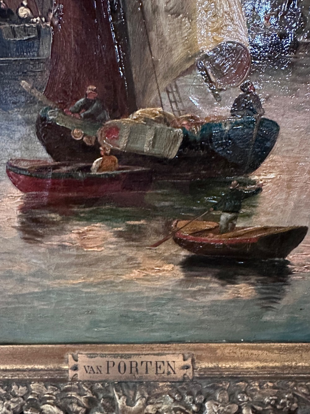 A pair of framed oil paintings on canvas depicting wooden sailing boats docked in a harbour within ornate gold leaf frames. View XI