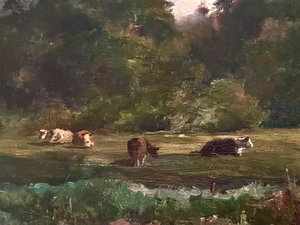 An antique late Victorian oil painting depicting a figure walking along a riverbank path in a rural countryside landscape, framed in a moulded giltwood frame. View VI