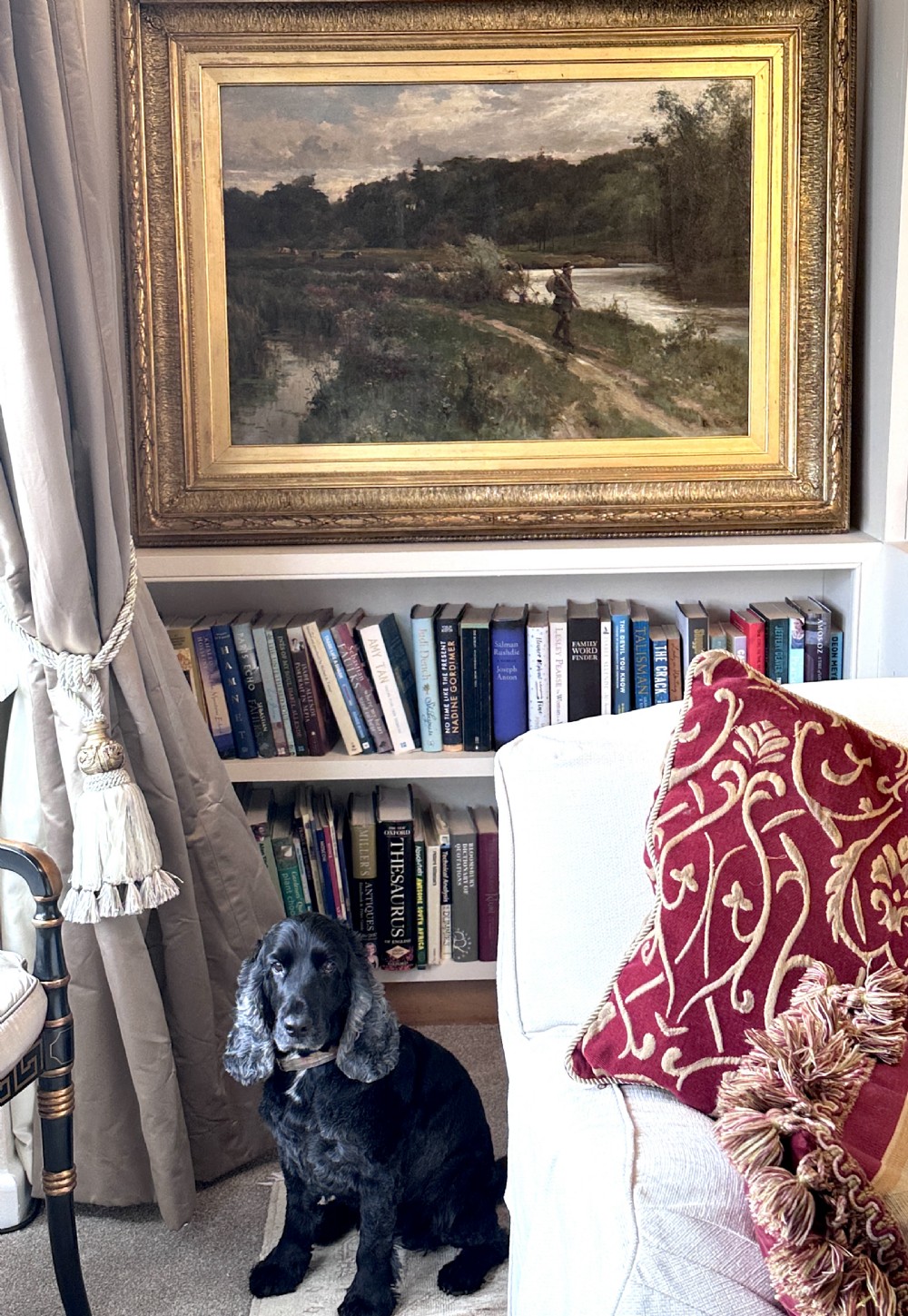 An antique late Victorian oil painting depicting a figure walking along a riverbank path in a rural countryside landscape, framed in a moulded giltwood frame. View IX