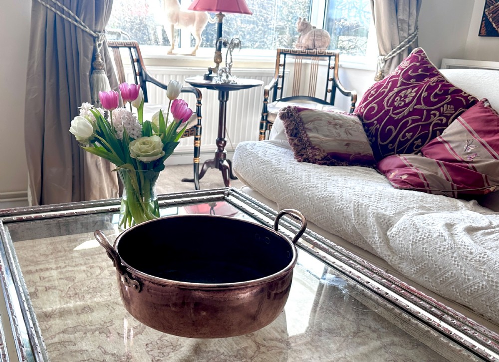 A circular polished copper preserving pan with rolled rim and twin riveted loop handles. View VIII