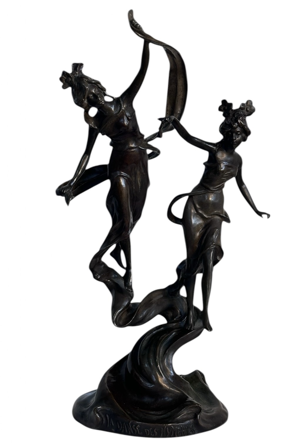 A dark patinated bronze sculpture depicting two dancing nymphs with flowing drapery set on a swirling base inscribed with La Danse des Nymphes.