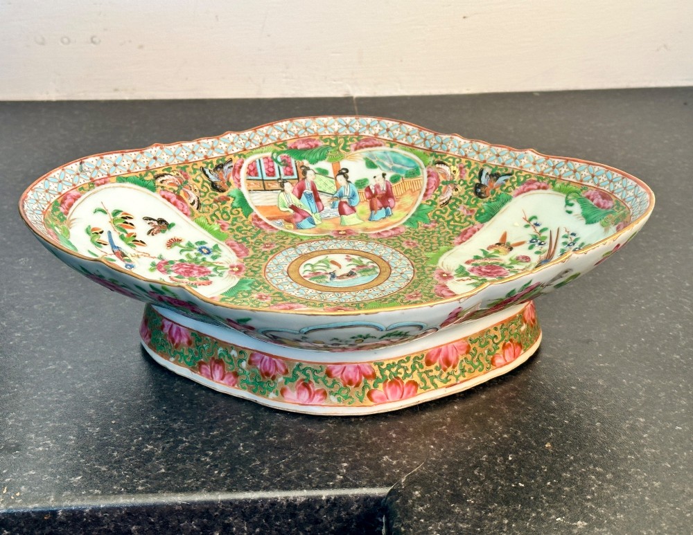 A 19th-century Chinese Canton export porcelain pedestal dish featuring hand-painted famille rose enamels with central figure scenes and floral motifs. View II