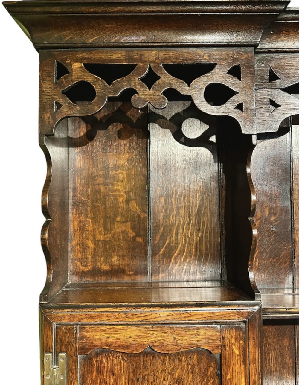 A dark oak George III dresser featuring an open plate rack top with side cupboards above three base drawers supported on cabriole legs. View X