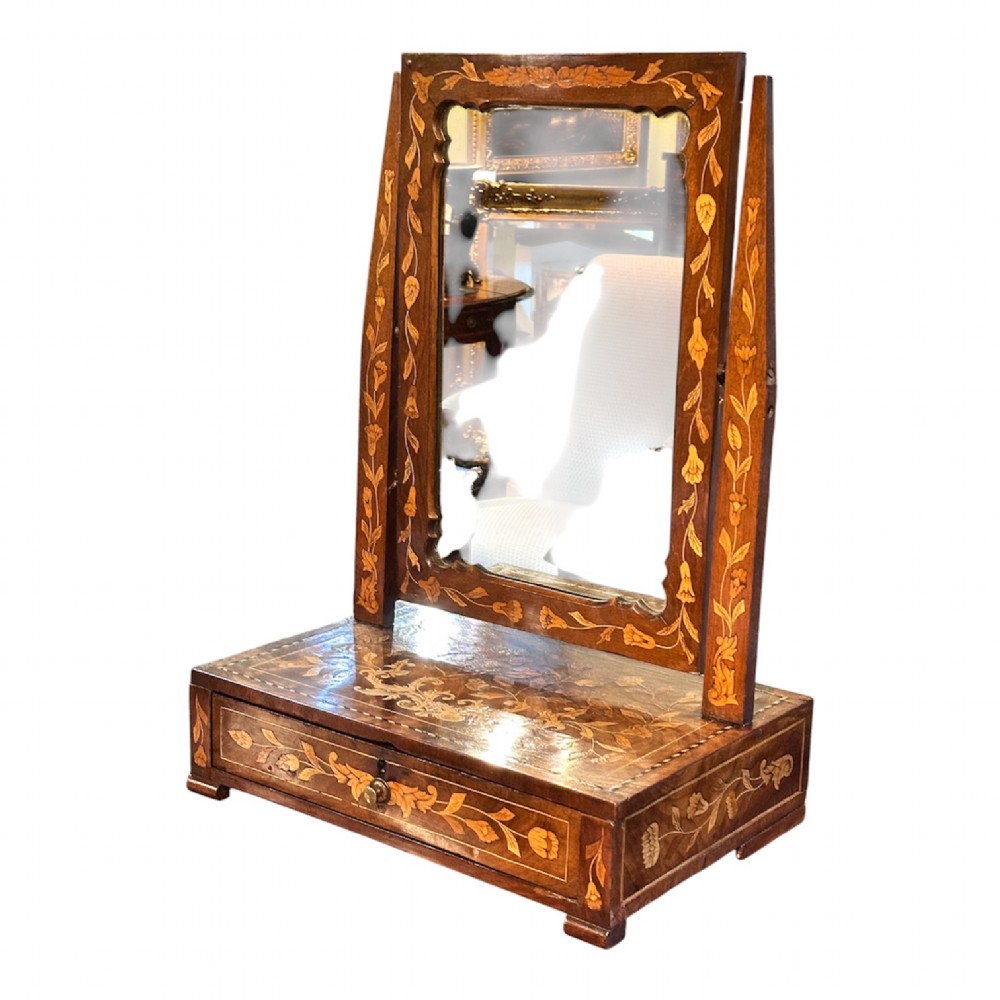 An antique Dutch walnut dressing table mirror featuring intricate floral marquetry inlay across the frame, support posts, and single-drawer base. View III