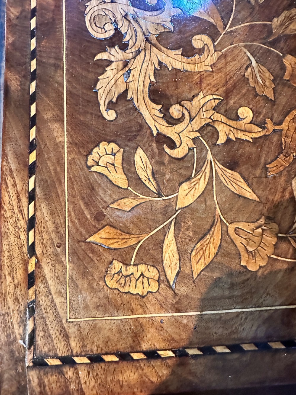 An antique Dutch walnut dressing table mirror featuring intricate floral marquetry inlay across the frame, support posts, and single-drawer base. View VIII