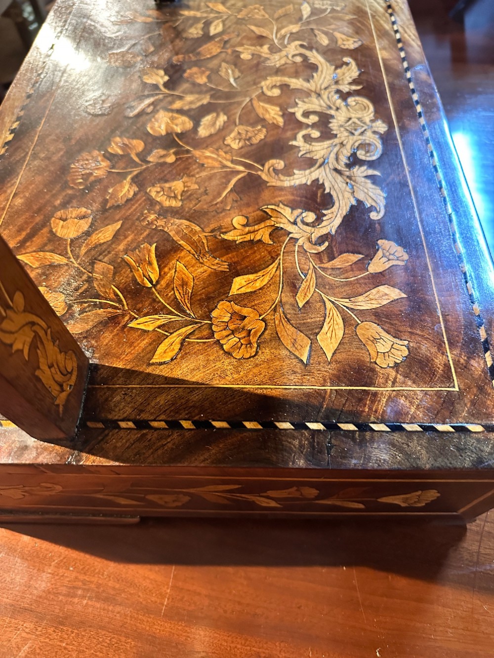 An antique Dutch walnut dressing table mirror featuring intricate floral marquetry inlay across the frame, support posts, and single-drawer base. View IX