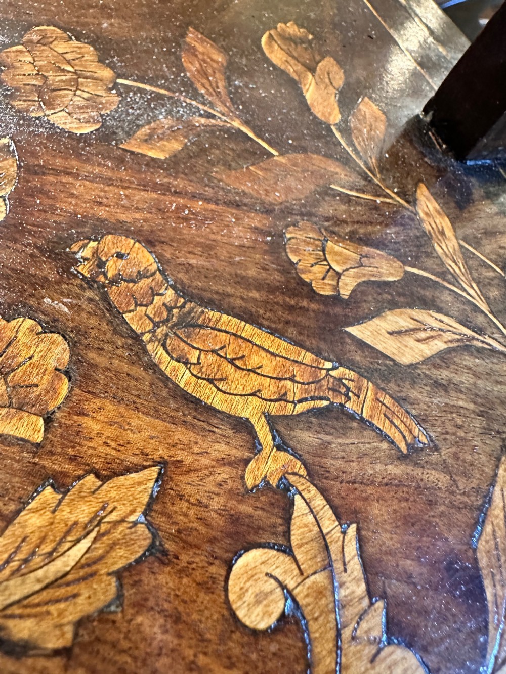 An antique Dutch walnut dressing table mirror featuring intricate floral marquetry inlay across the frame, support posts, and single-drawer base. View X