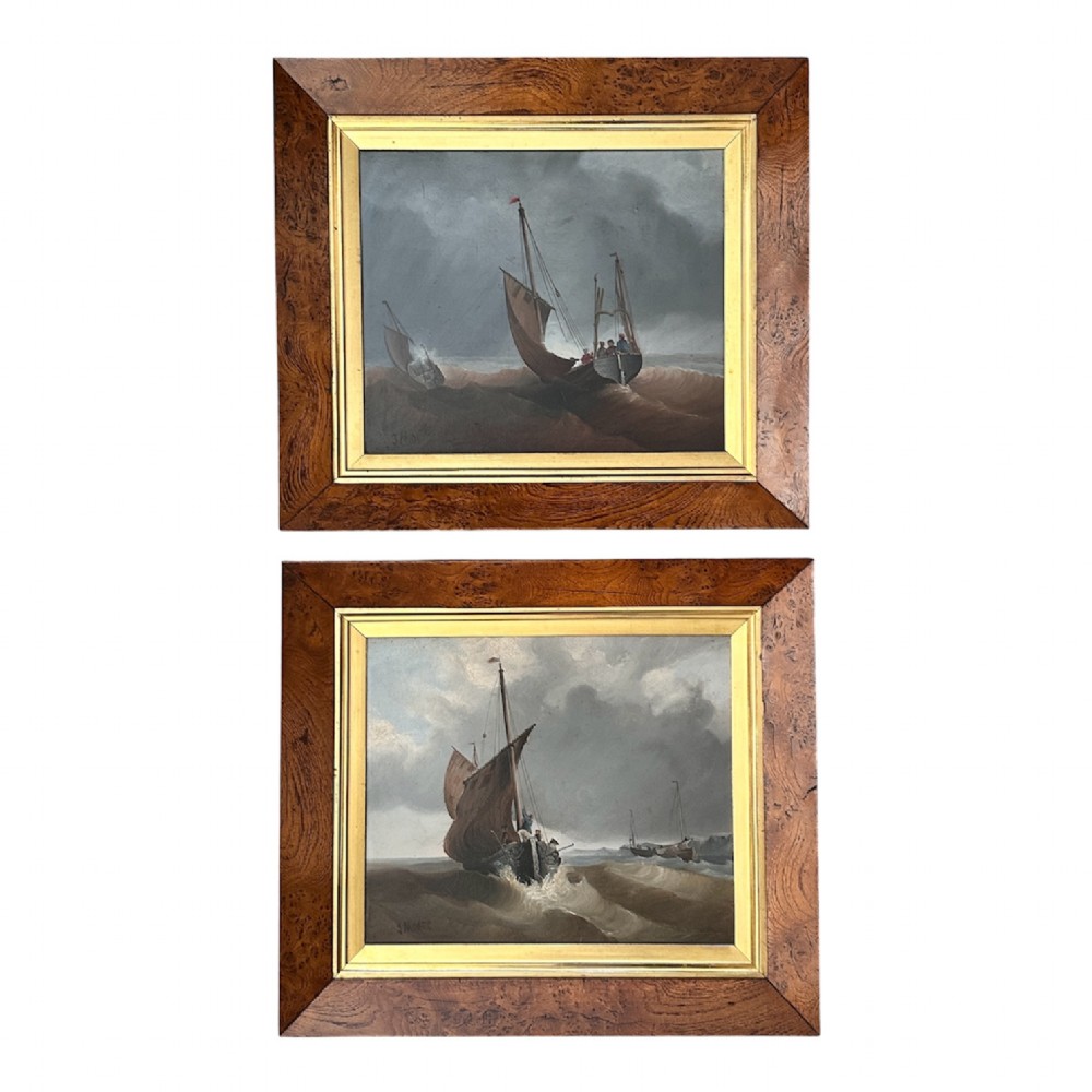 A pair of Victorian marine oil paintings depicting sailing boats navigating choppy seas, encased in wide burr wood frames with gilded slips.