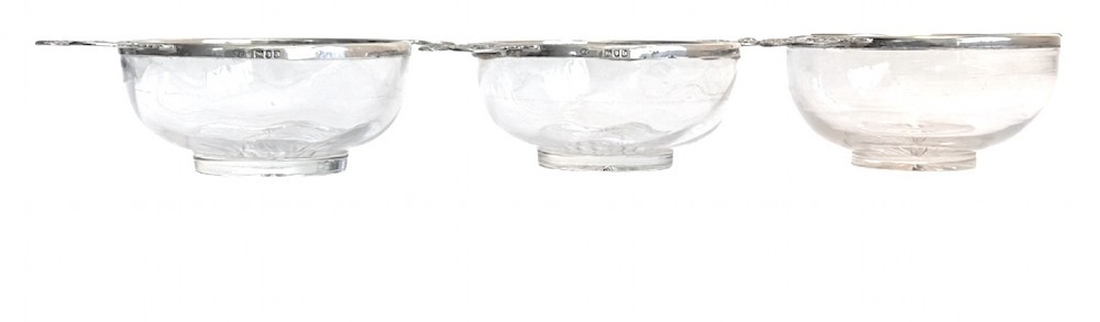 A set of three clear glass bowls featuring sterling silver rims and pierced scroll handles. View IV