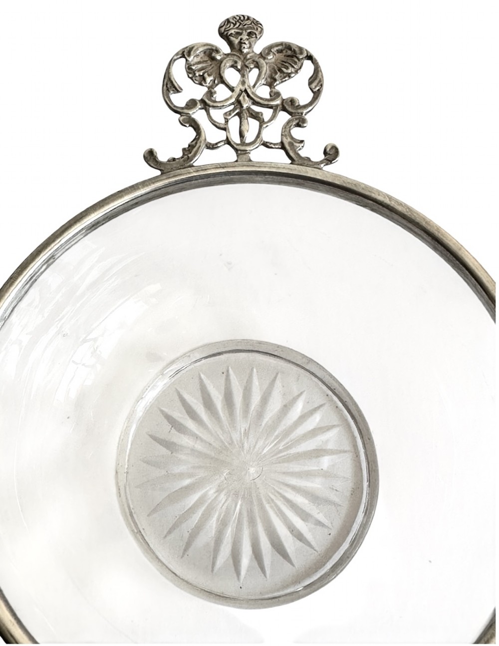 A set of three clear glass bowls featuring sterling silver rims and pierced scroll handles. View V
