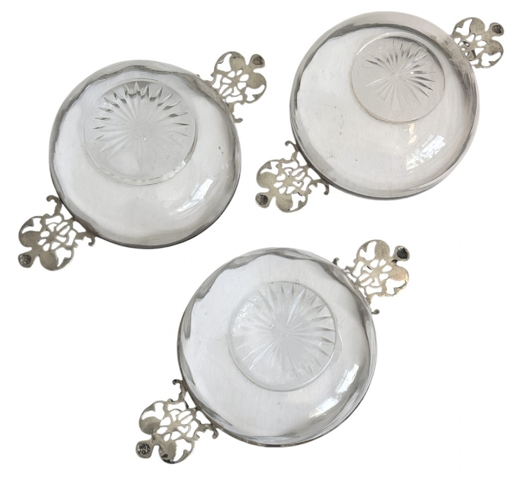 A set of three clear glass bowls featuring sterling silver rims and pierced scroll handles. View VI