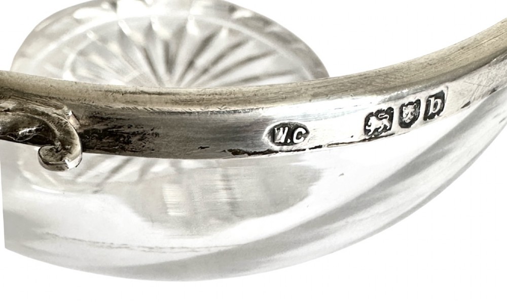 A set of three clear glass bowls featuring sterling silver rims and pierced scroll handles. View VII