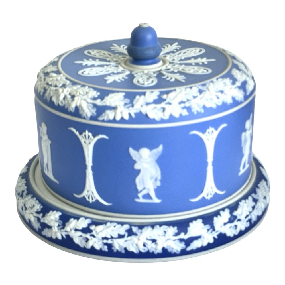 A Victorian blue Jasperware cheese dome and base decorated with white neoclassical figures, oak leaf garlands, and a central finial handle.