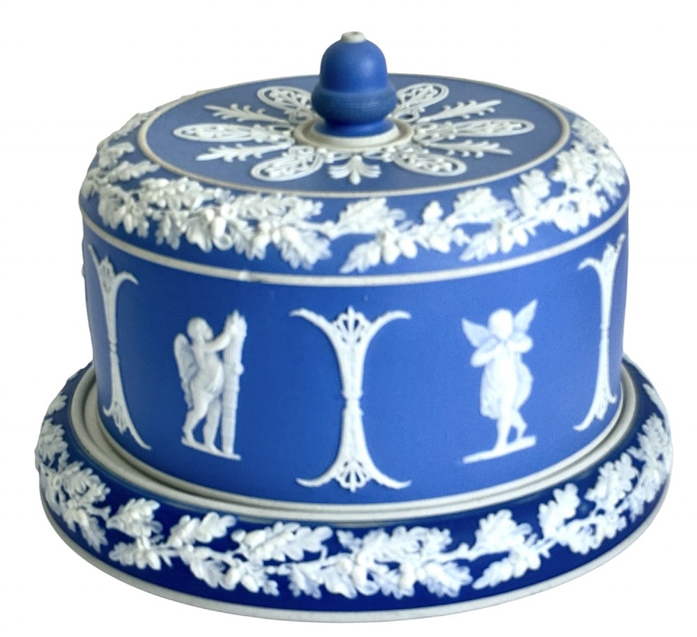 A Victorian blue Jasperware cheese dome and base decorated with white neoclassical figures, oak leaf garlands, and a central finial handle. View III