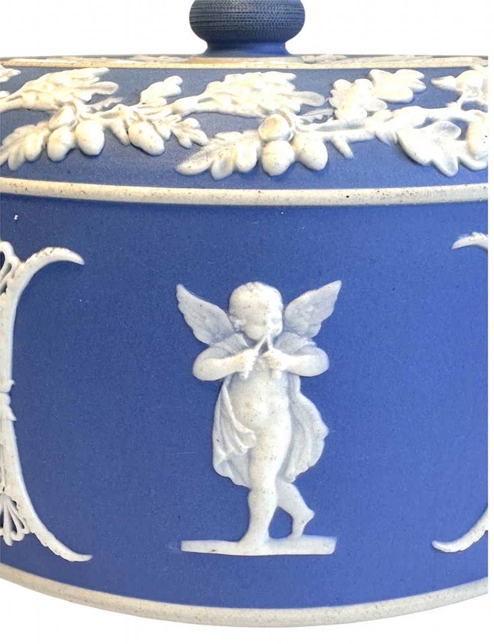 A Victorian blue Jasperware cheese dome and base decorated with white neoclassical figures, oak leaf garlands, and a central finial handle. View XI