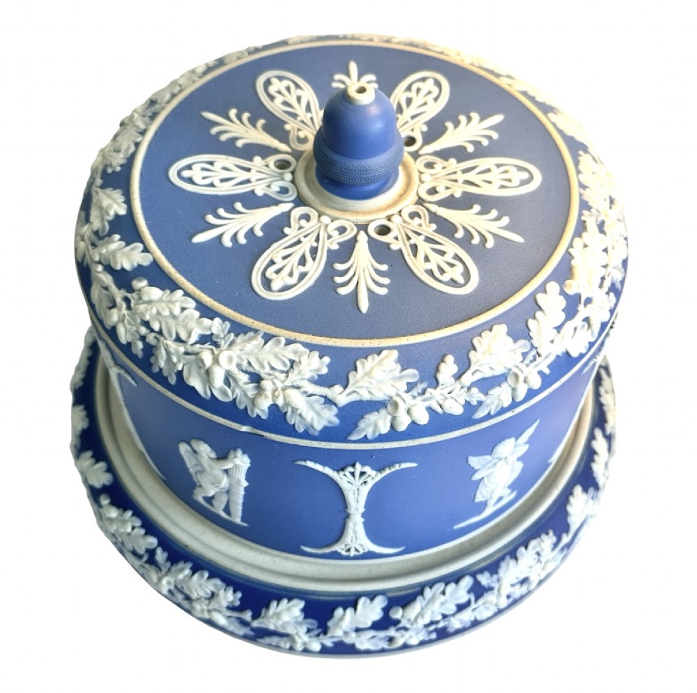 A Victorian blue Jasperware cheese dome and base decorated with white neoclassical figures, oak leaf garlands, and a central finial handle. View XIII