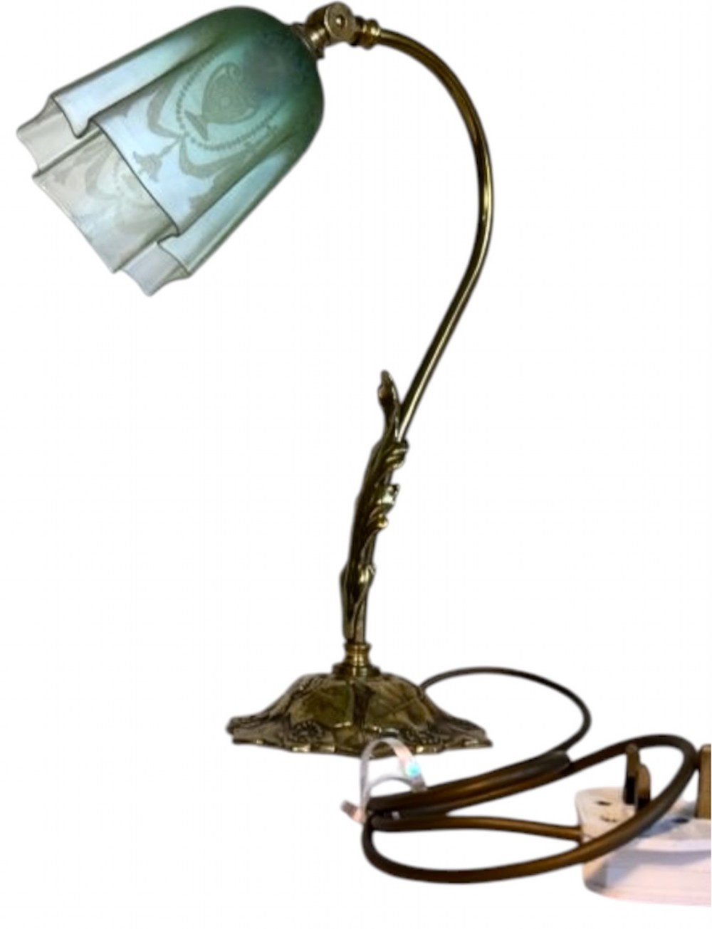 An Edwardian brass desk lamp featuring a curved swan-neck stem with leaf motifs and a frilled green etched glass shade.