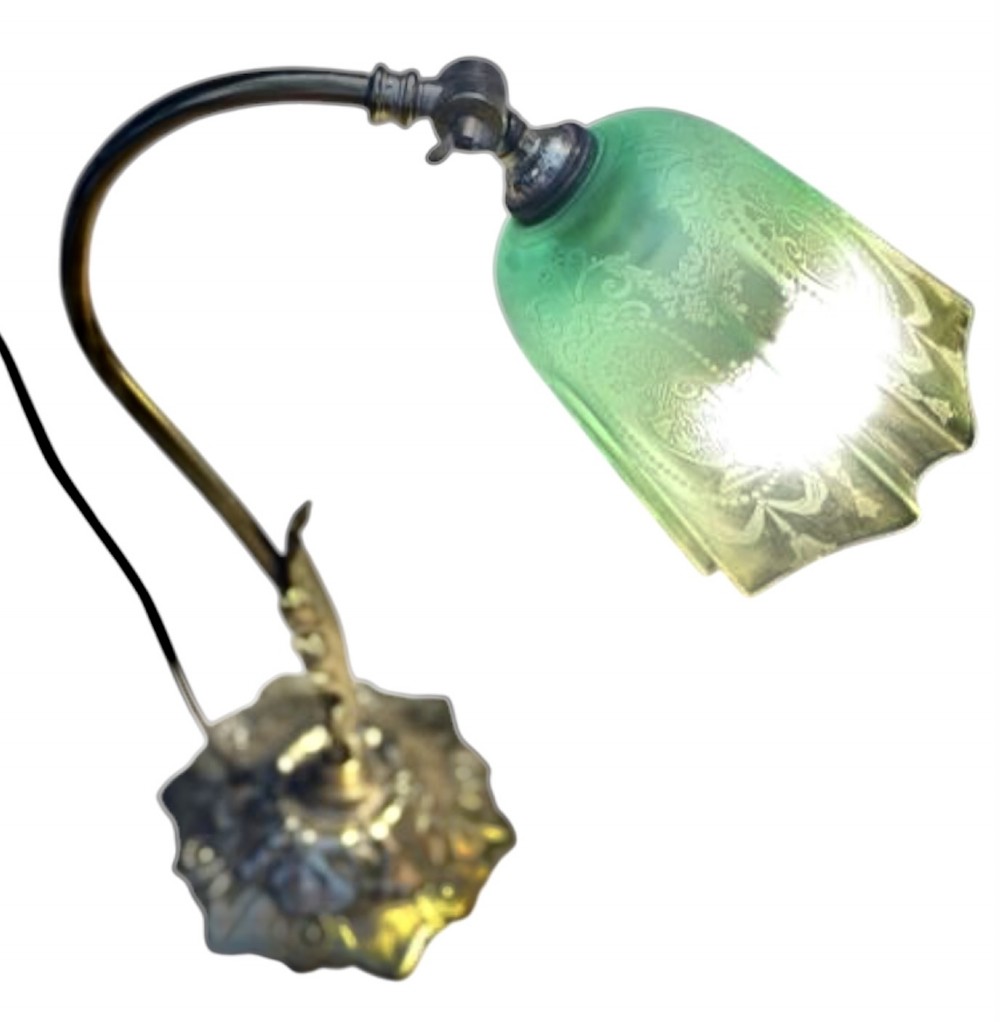 An Edwardian brass desk lamp featuring a curved swan-neck stem with leaf motifs and a frilled green etched glass shade. View VI
