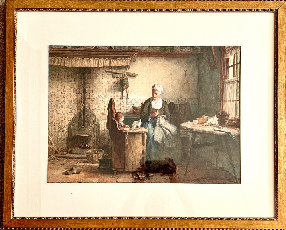 A framed 19th-century watercolour painting depicting a woman seated beside a child in a traditional Dutch kitchen interior with a tiled fireplace.