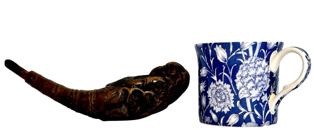 A dark brown carved bamboo smoking pipe shaped into a figurative human form along the bowl with a tapered bamboo stem. View XI
