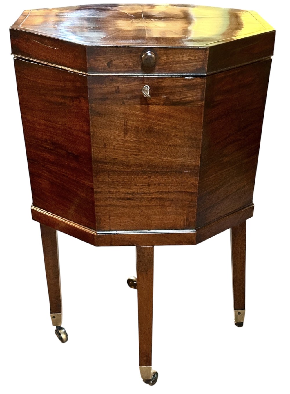 An octagonal George III mahogany cellarette on tapered legs with brass castors, featuring a starburst veneered lid and inlaid detailing. View III