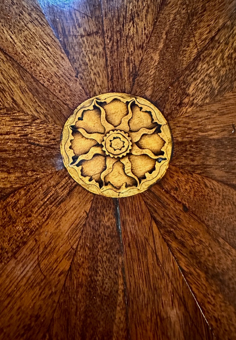 An octagonal George III mahogany cellarette on tapered legs with brass castors, featuring a starburst veneered lid and inlaid detailing. View IV