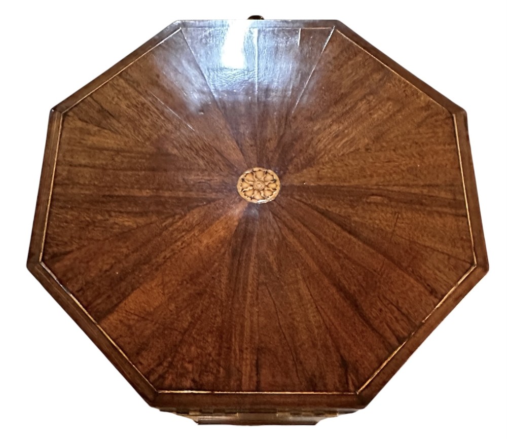 An octagonal George III mahogany cellarette on tapered legs with brass castors, featuring a starburst veneered lid and inlaid detailing. View X