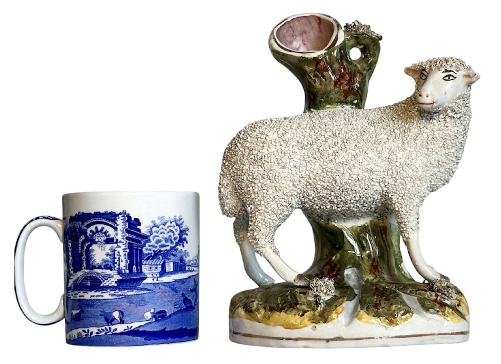 A pair of Victorian Staffordshire earthenware spill vases depicting textured woolly sheep standing alongside green tree trunk vessels. View III
