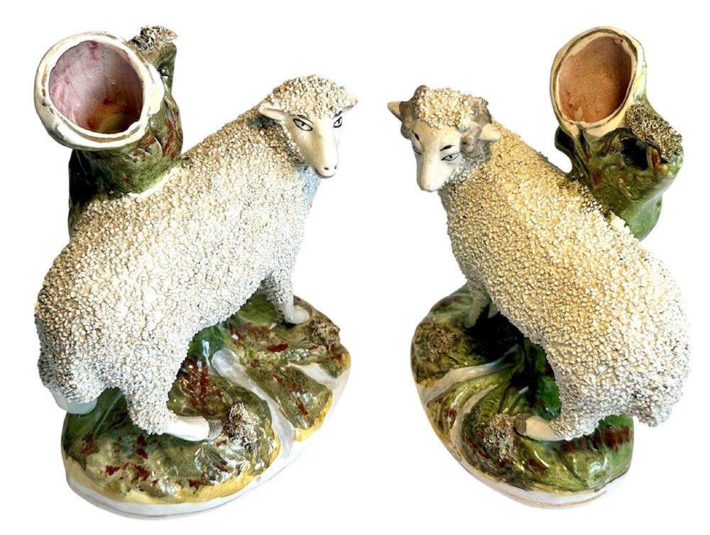 A pair of Victorian Staffordshire earthenware spill vases depicting textured woolly sheep standing alongside green tree trunk vessels. View VIII