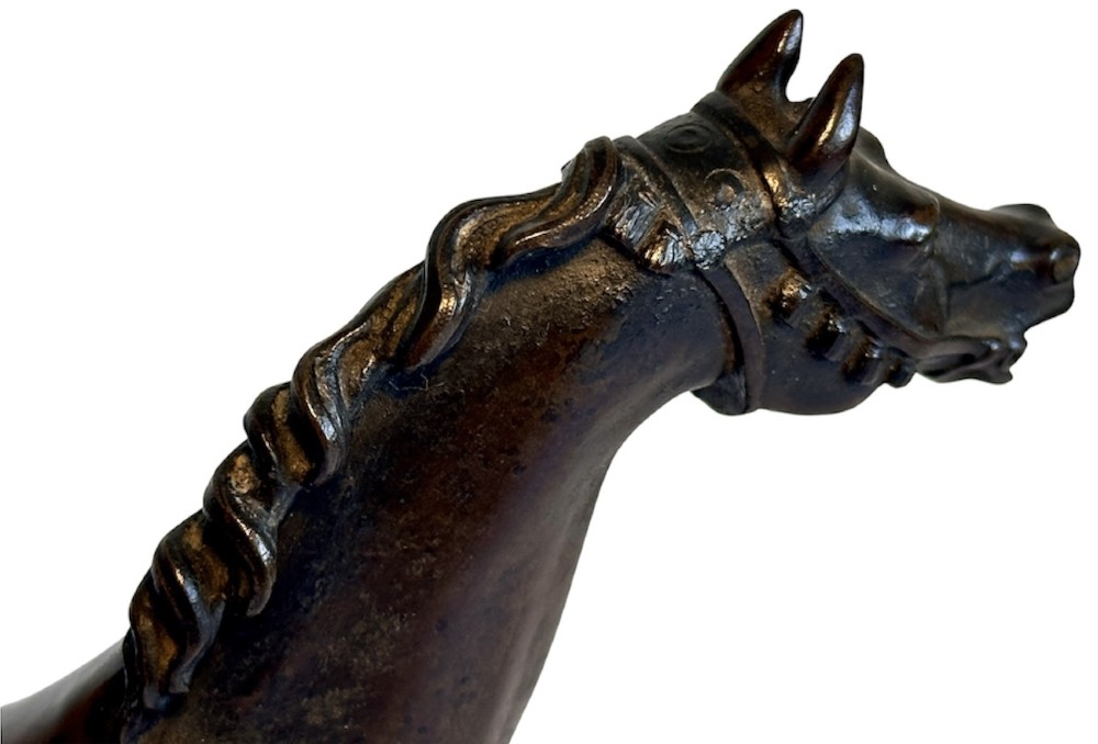 A dark patinated bronze sculpture of a trotting stallion mounted on a rectangular veined red marble plinth. View IX