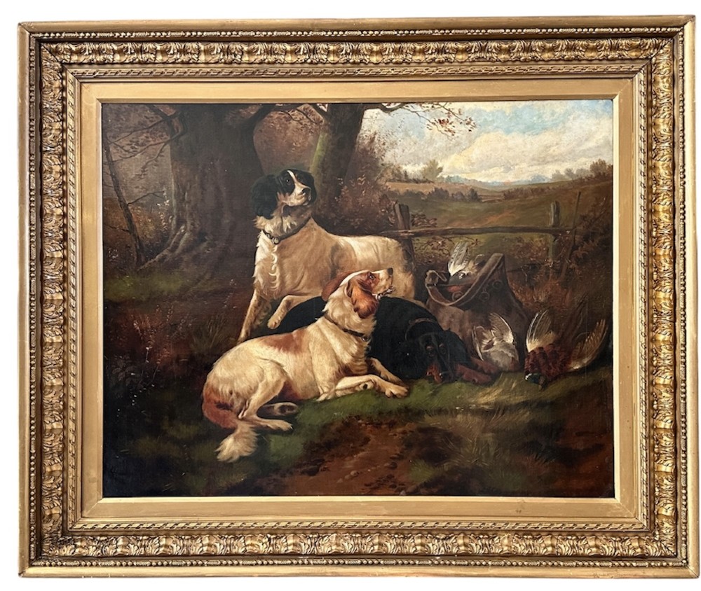 An oil painting on canvas depicting gun dogs lying beside harvested game birds in a rural landscape, framed in an ornate gold leaf frame.
