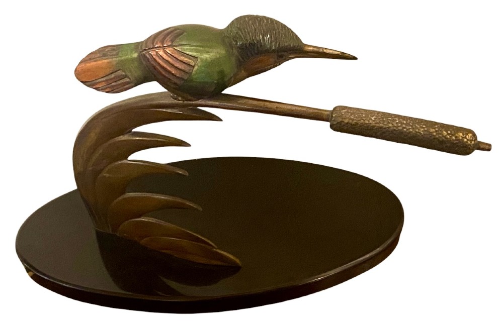 An Art Deco cold-painted bronze sculpture depicting a stylized kingfisher perched on swept curved reeds, set upon an oval dark marble base. View III