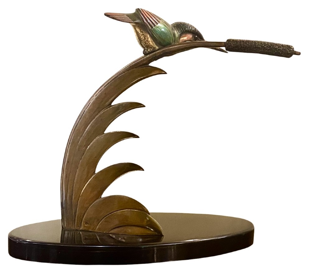 An Art Deco cold-painted bronze sculpture depicting a stylized kingfisher perched on swept curved reeds, set upon an oval dark marble base. View IV