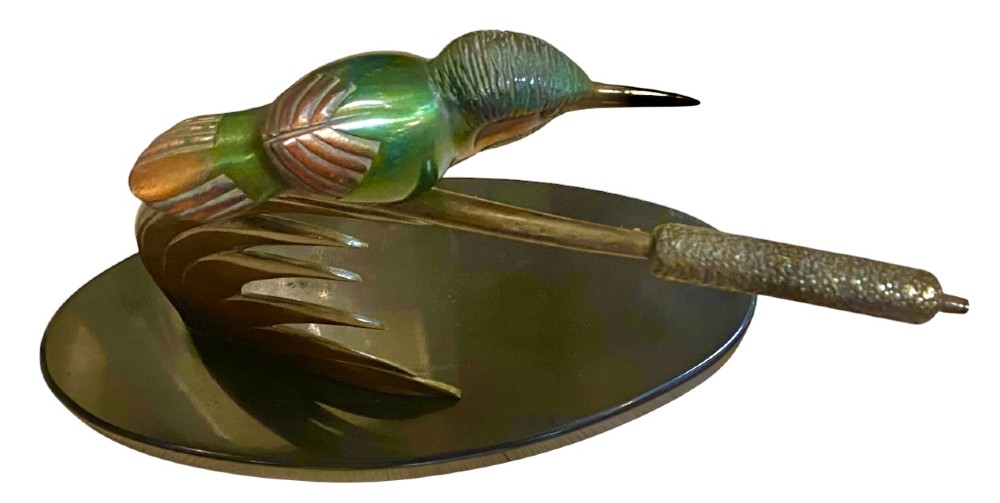 An Art Deco cold-painted bronze sculpture depicting a stylized kingfisher perched on swept curved reeds, set upon an oval dark marble base. View V