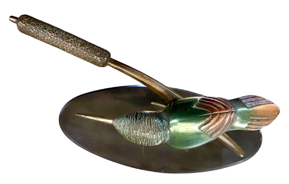 An Art Deco cold-painted bronze sculpture depicting a stylized kingfisher perched on swept curved reeds, set upon an oval dark marble base. View VI